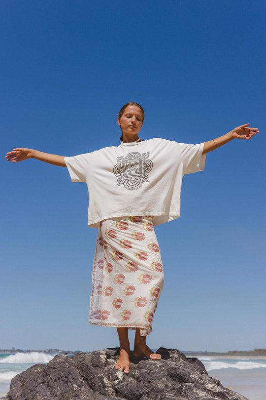 Shanti Tee White — studio back view, white oversized cotton tee showing clean back and boxy fit, paired with spearmint striped pants, white backdrop | Daughters of India