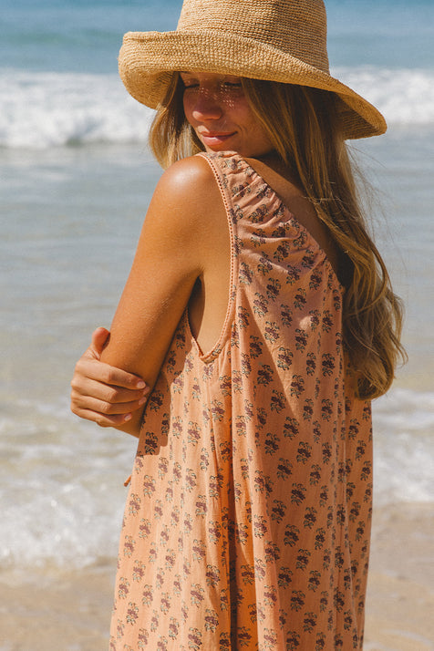 Sundress Midi Peach — studio full length front view, model facing camera, sleeveless sundress with tie-gather neckline, flared A-line skirt, hand block print peach floral cotton, artisan Jaipur India | Daughters of India