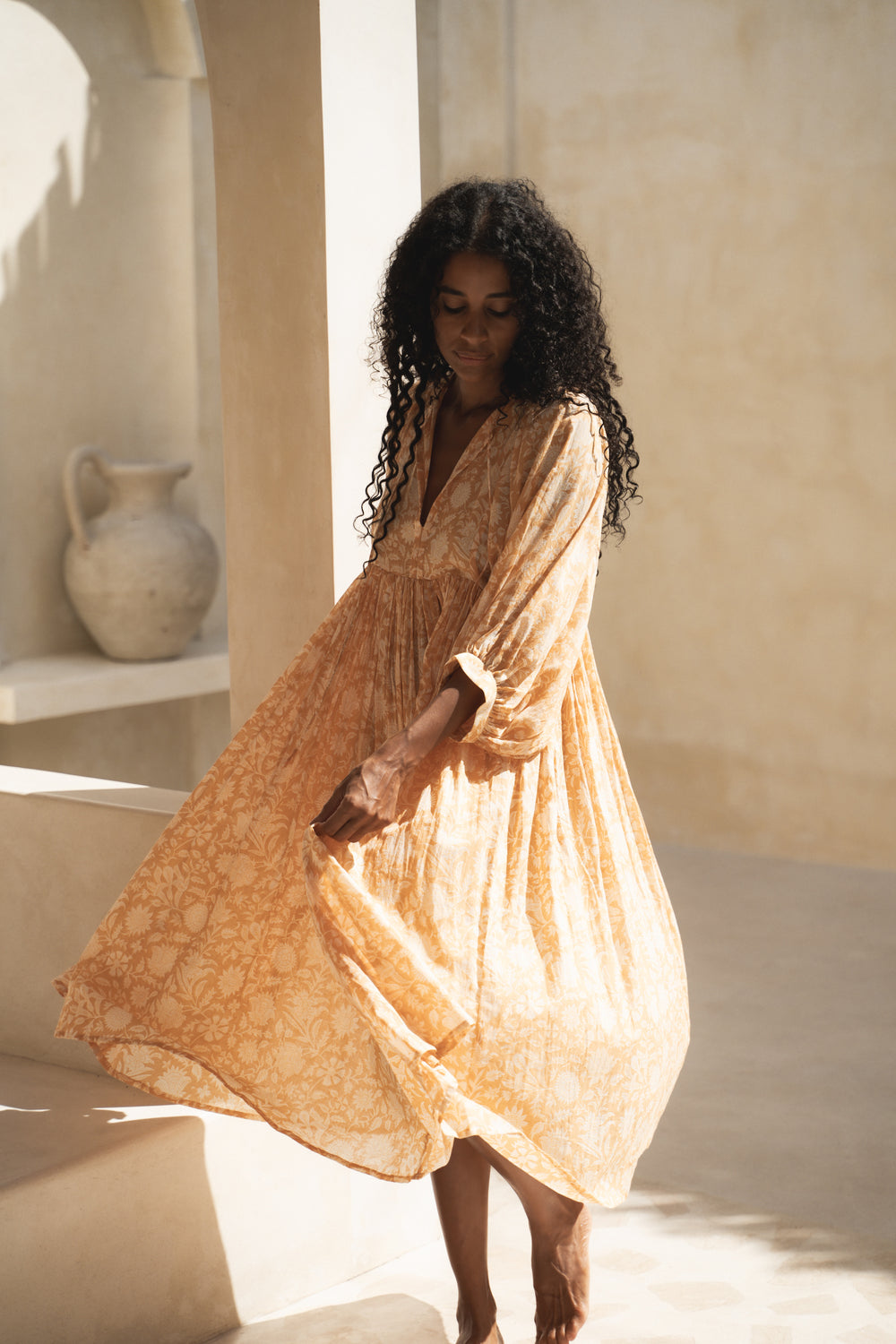 Daughters of India Kyra Midi Dress in Tangerine — twirling in golden light, hand screen print cotton